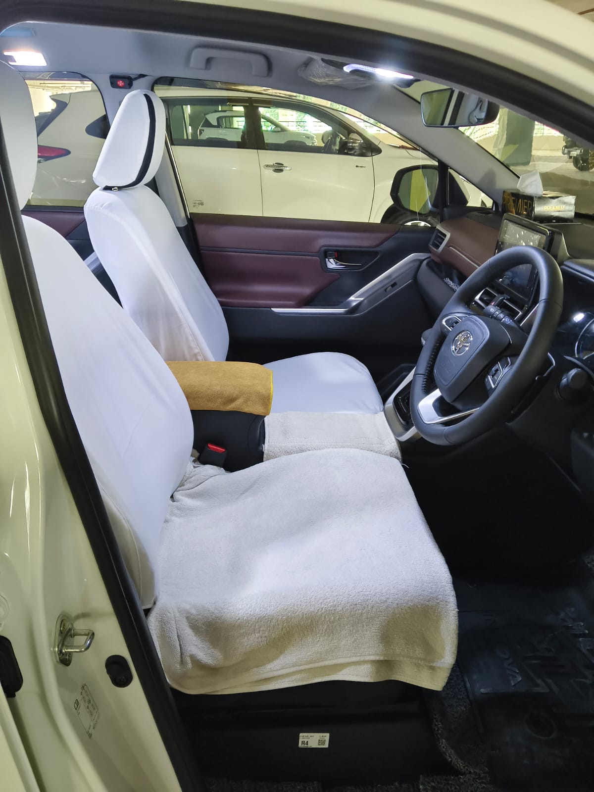 Front seats with clean white covers in our Innova Hycross