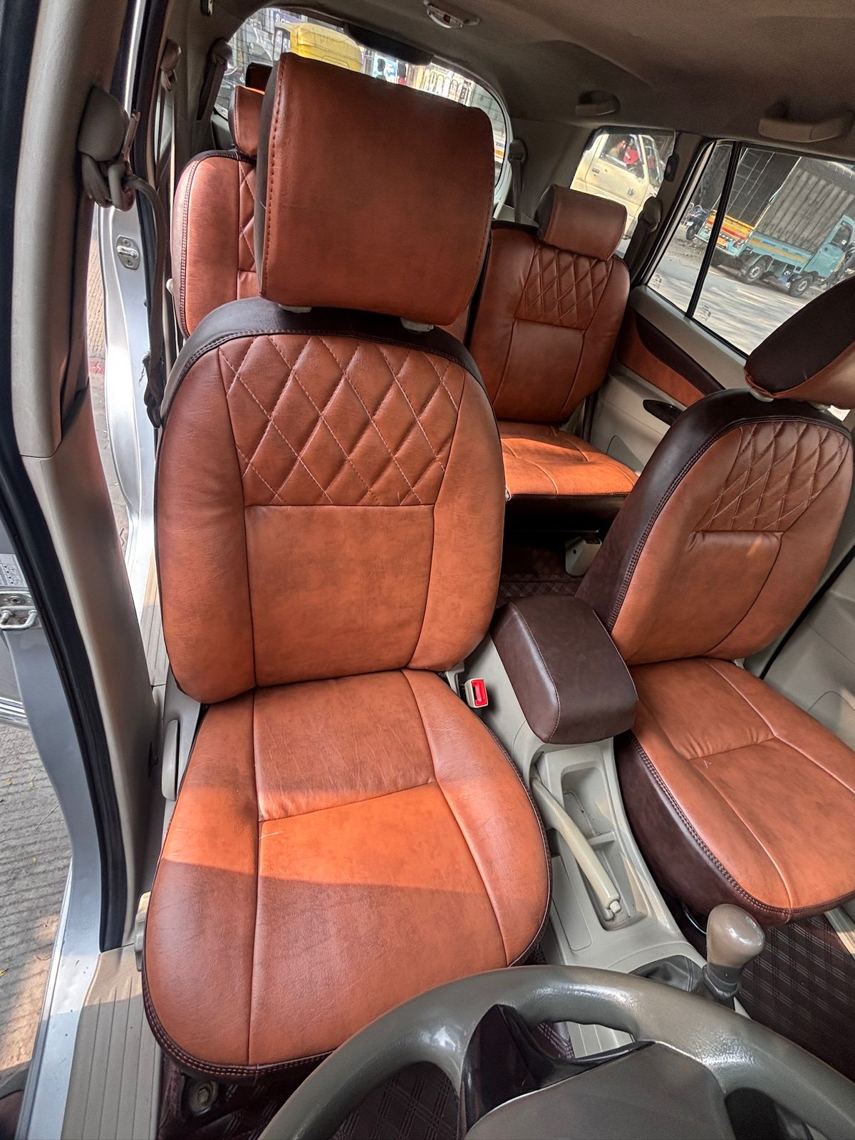 Tan leather front seats in our Toyota Innova