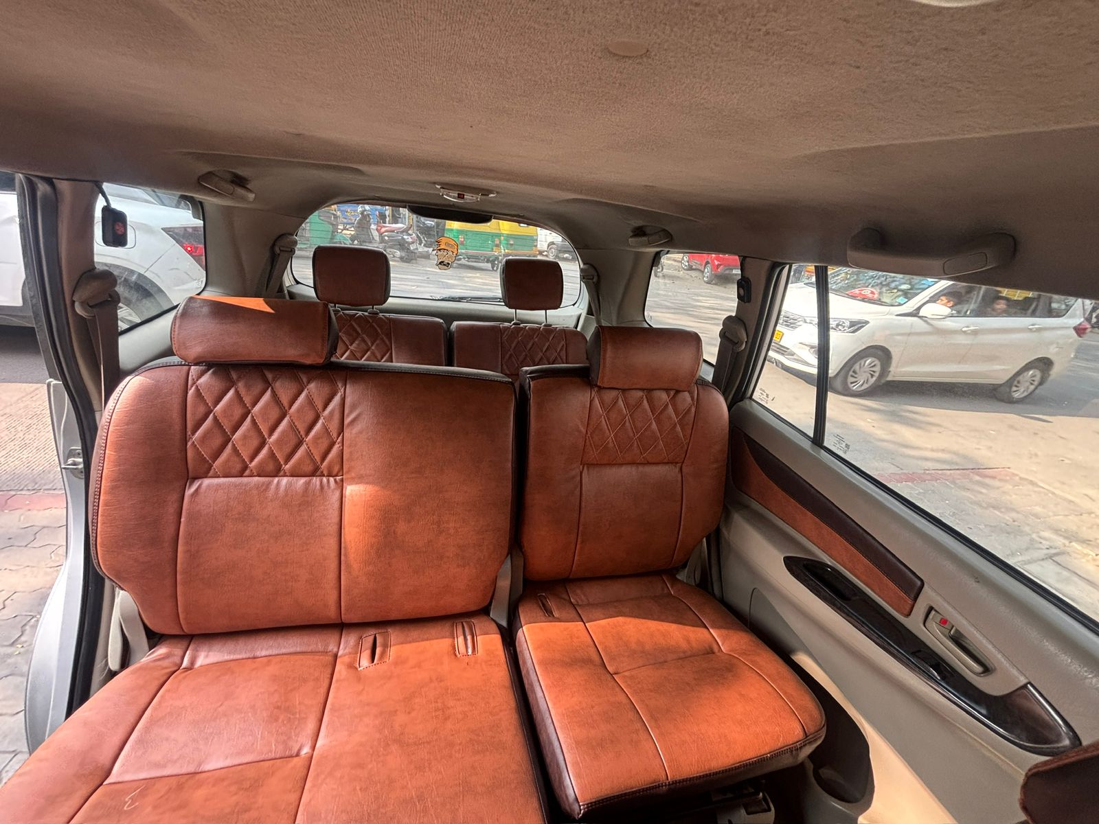 Tan leather second and third row seats in our Toyota Innova